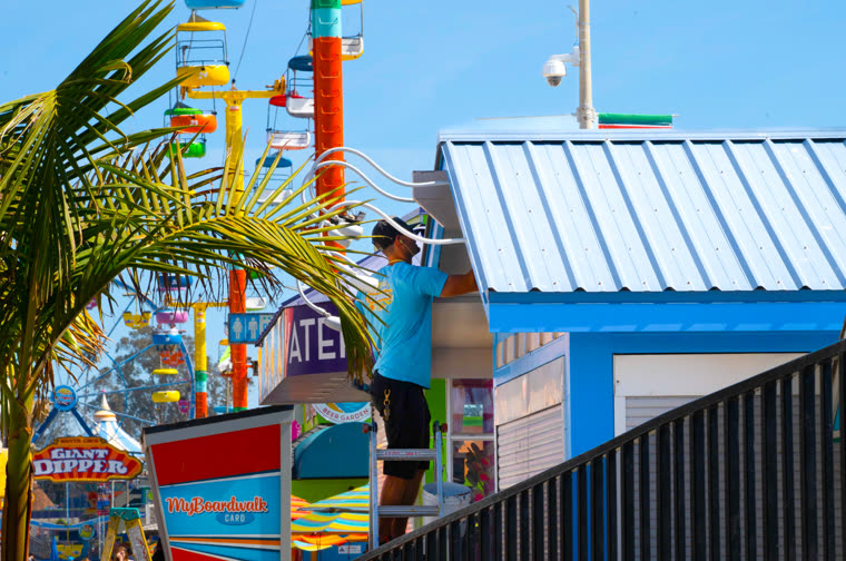 Colourful boardwalk buildings under a clear blue sky