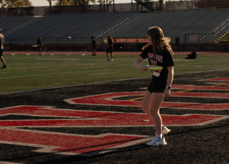 An athlete warming up on a school track and field